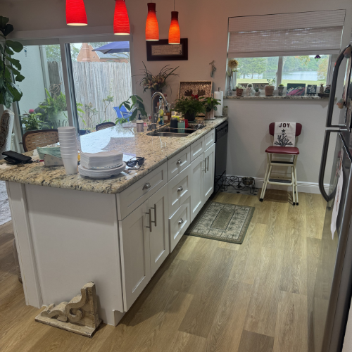 kitchen island, overhead lighting, and flooring installation